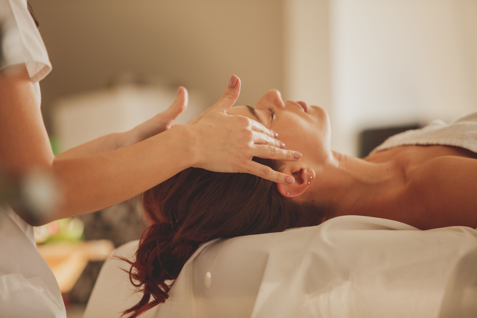 Woman enjoying a facial massage at the beauty spa